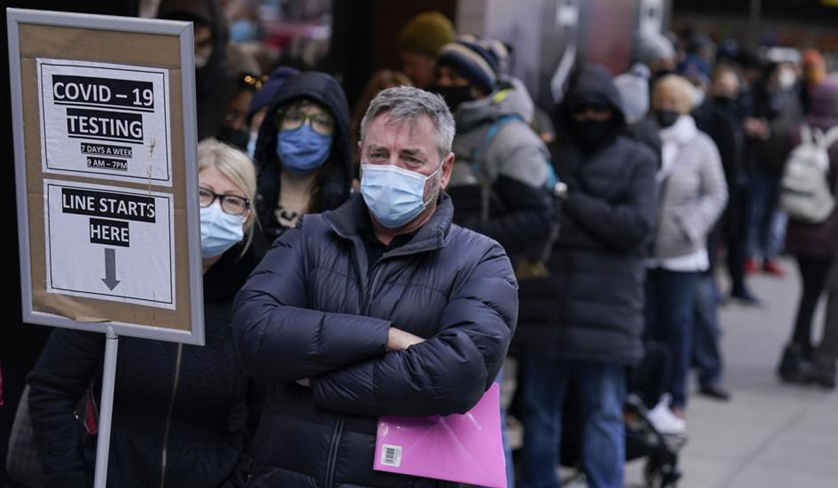 People wait in line at a COVID-19 testing site in Times Square